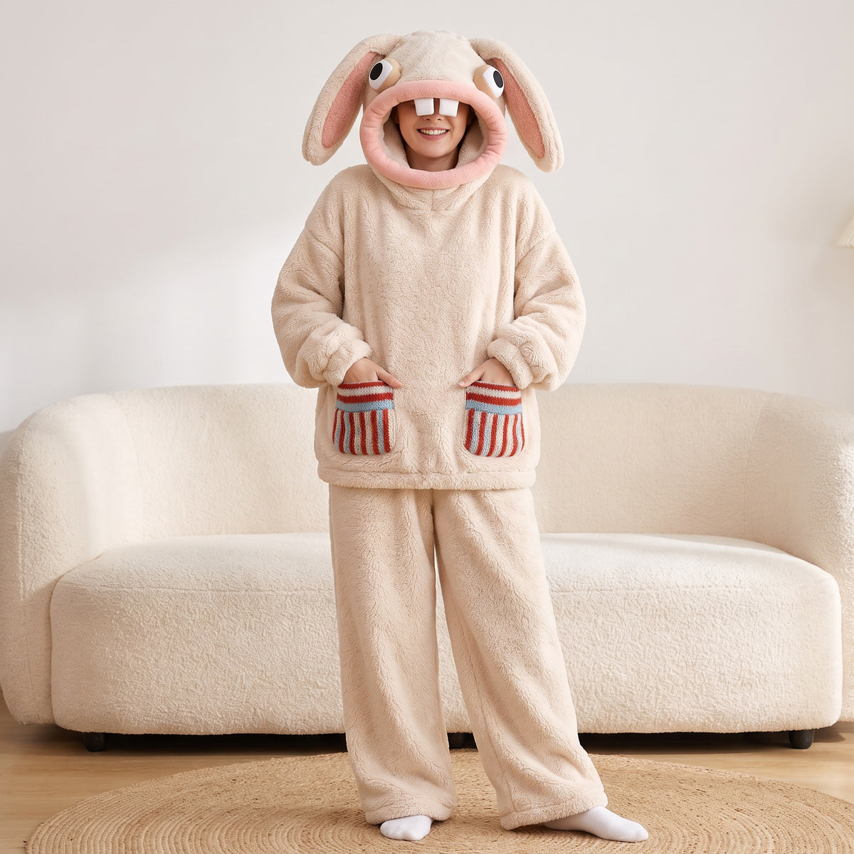 Hoppenstein bunny set in Cream, hands in the striped knit pockets