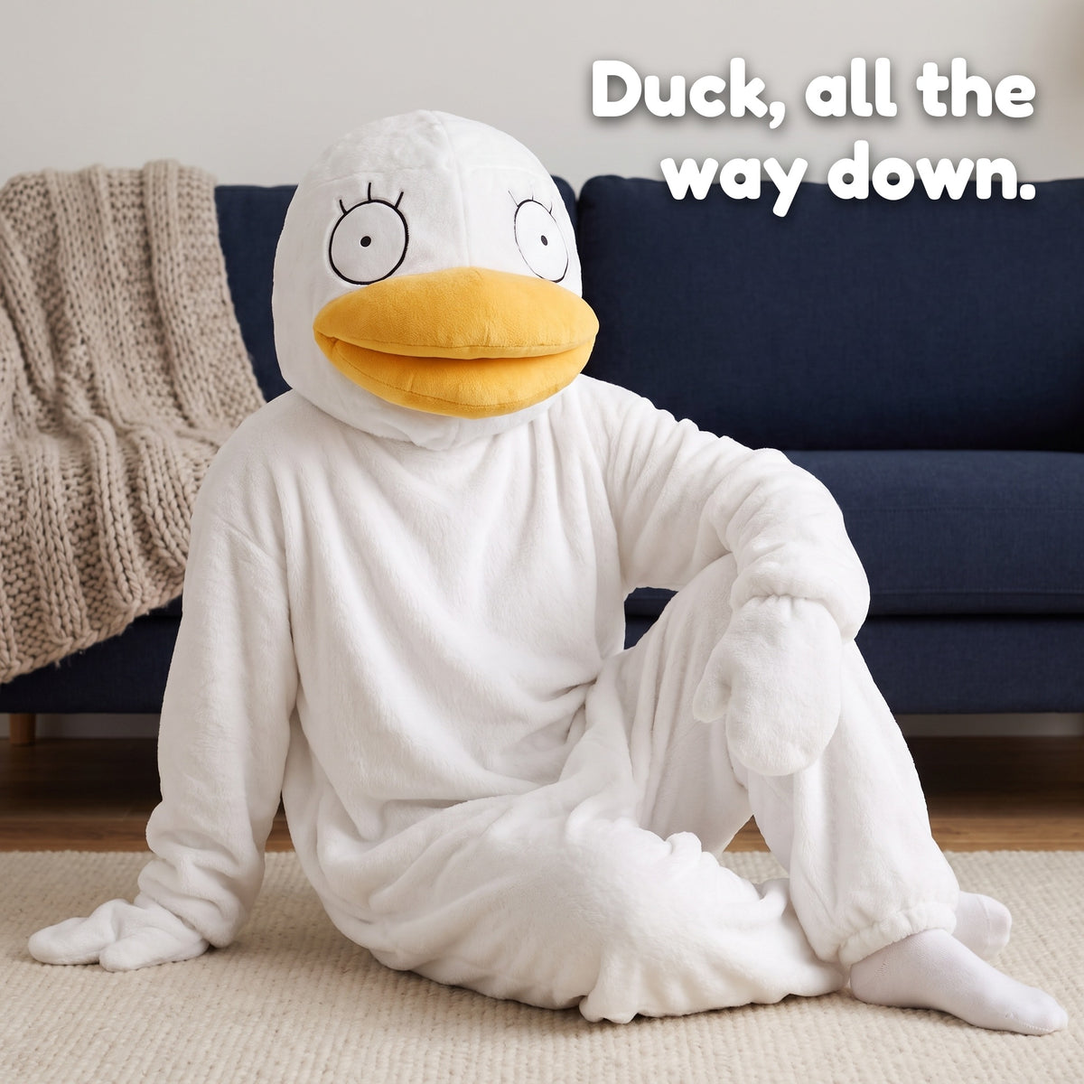 Quackenstein duck onesie in White, sitting on the rug