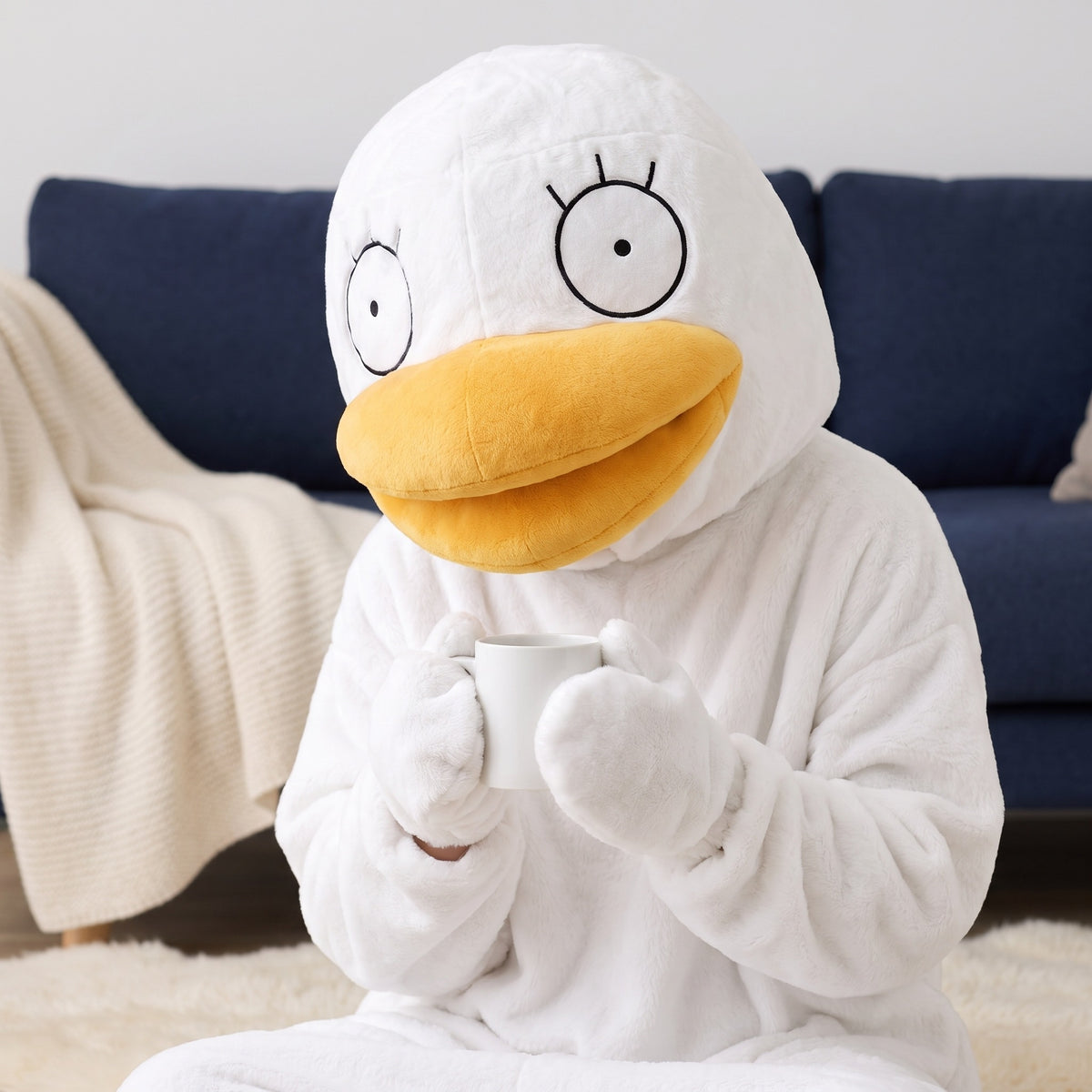 Quackenstein duck onesie in White, mittens around a mug